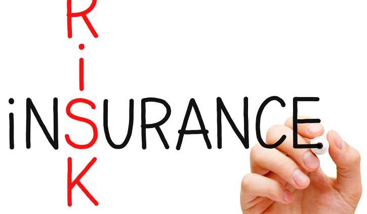Cross word on s between the words "risks" and "isurance" written on board by a hand