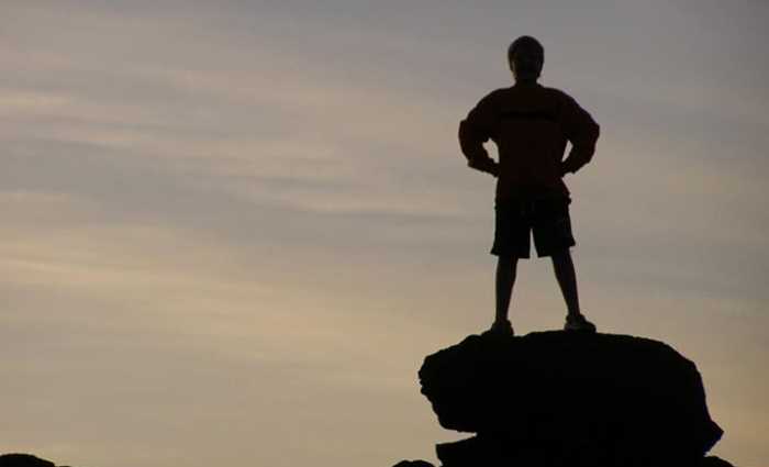 rock climber at the top of a mountain