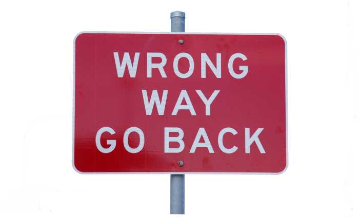 wrong-way road signboard, white letters on red background