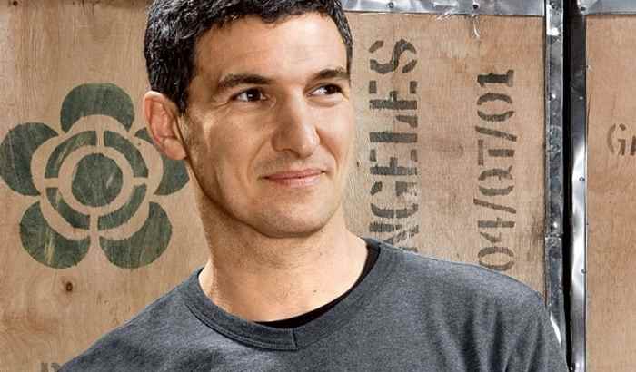 Seth Goldma founder on honest tea, in front of a wooden tea box