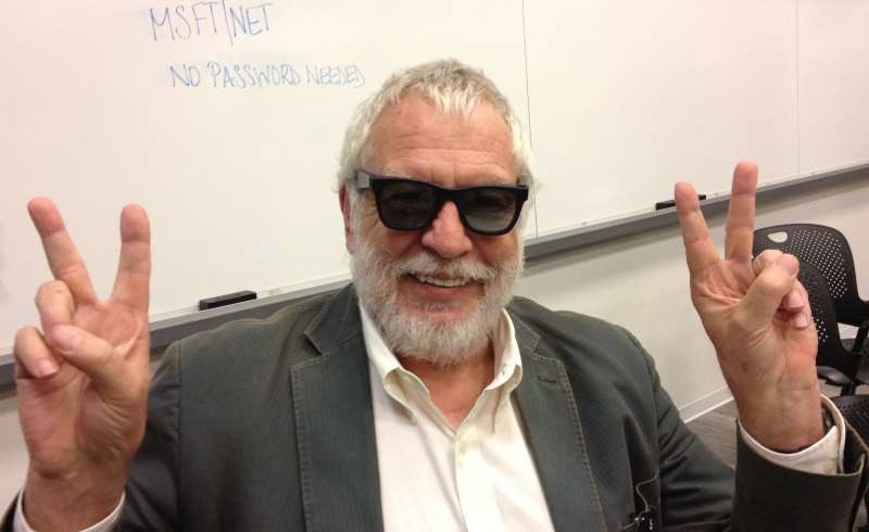 Nolan Bushnell, founder of Atari, with sun glasses and fingers in V