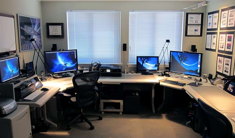 home office with multiple computer screens