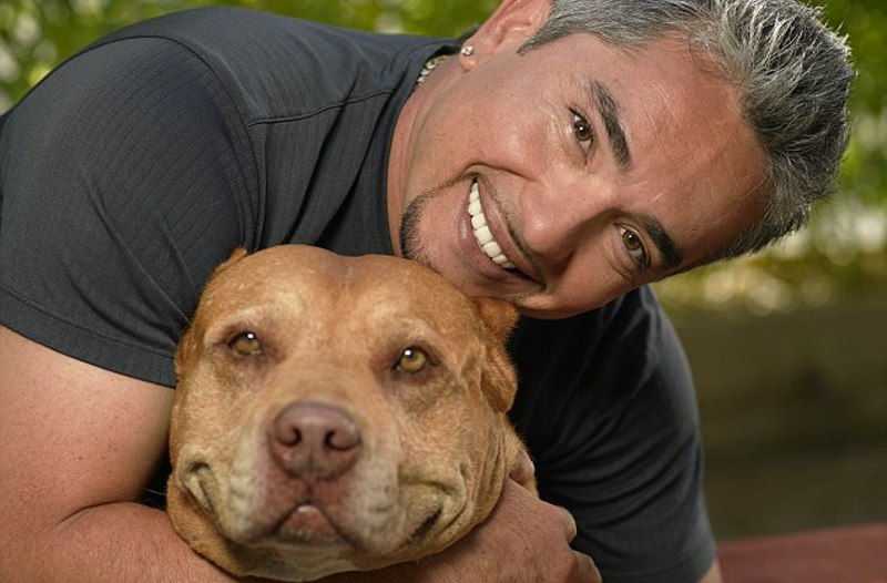 well know Cesar hugging a dog