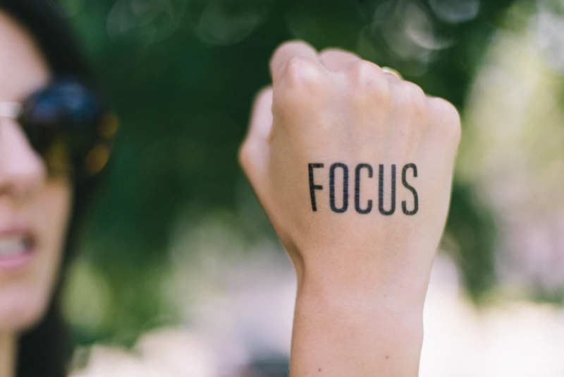 woman with the word focus on her fist