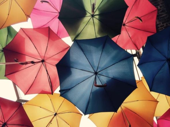 multicolor umbrella in the sky as a symbol of protection