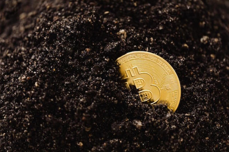 bitcoin in black sand