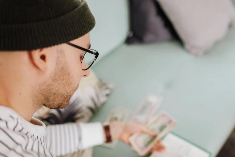 man counting banknotes