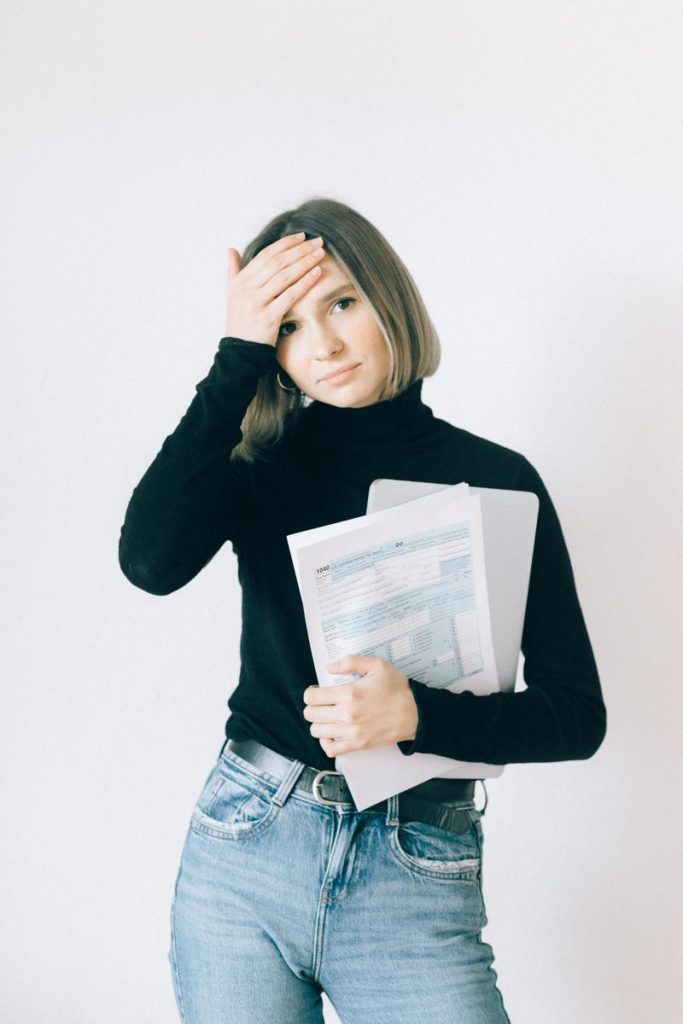 woman holding income tax forms