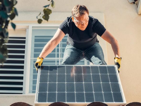 man installing solar panels