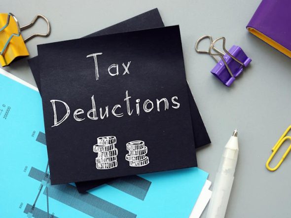 Business concept meaning Tax Deductions with inscription on the sheet.
