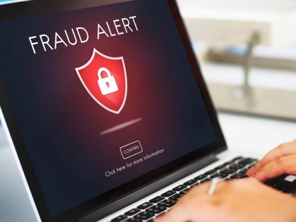 laptop showing fraud alert on scree